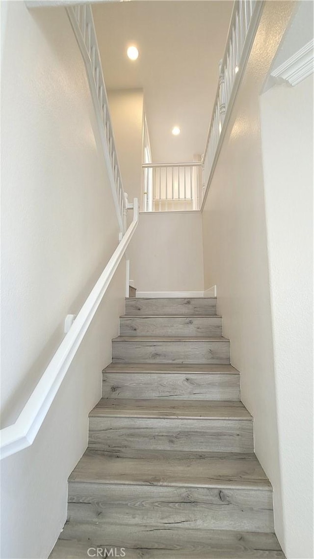 stairway featuring recessed lighting