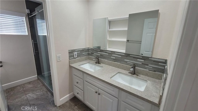 full bath with a shower stall, decorative backsplash, and a sink