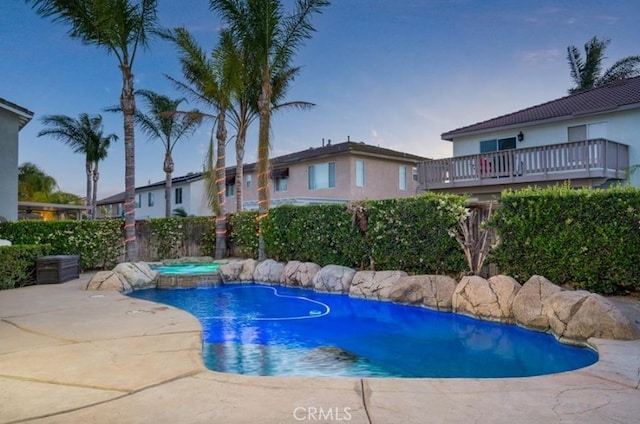 view of pool with a patio area, a fenced backyard, a fenced in pool, and an in ground hot tub