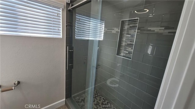 full bathroom with a stall shower and a textured wall