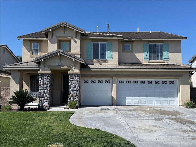 view of front of home with an attached garage, a front yard, concrete driveway, and stucco siding