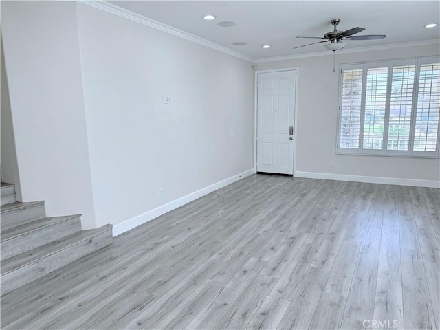 empty room with crown molding, recessed lighting, stairway, wood finished floors, and baseboards