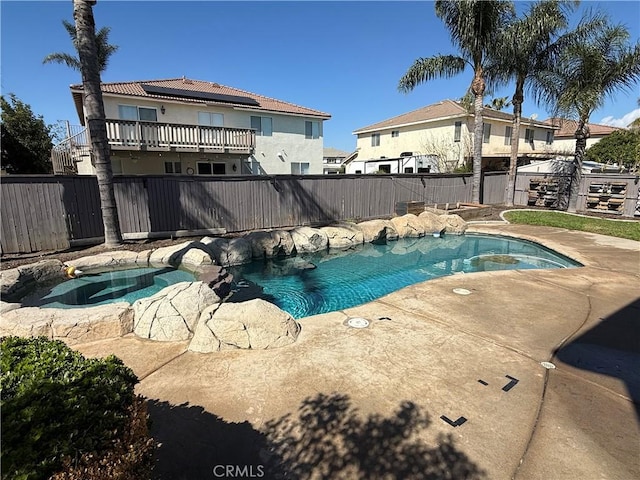 view of pool featuring an in ground hot tub, a patio, a fenced backyard, and a fenced in pool