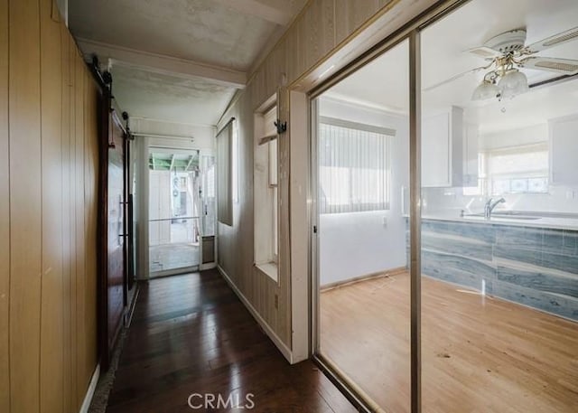 2116 Rancho Rd, El Sobrante, CA 94803 - corridor featuring dark wood-style floors, a barn door, and crown molding