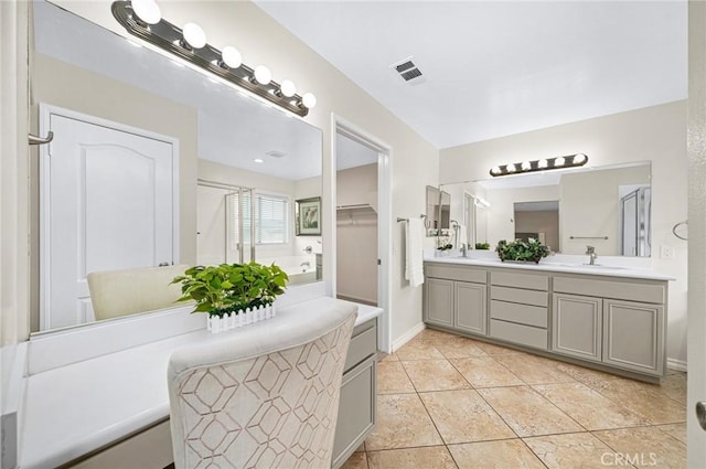 full bath featuring tile patterned flooring, a sink, visible vents, double vanity, and a stall shower