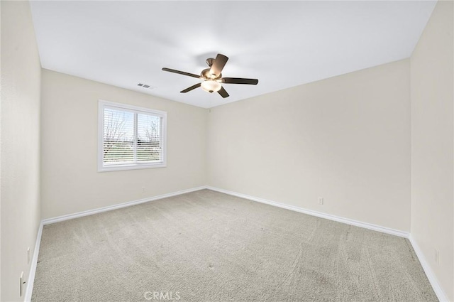 unfurnished room featuring a ceiling fan, carpet flooring, visible vents, and baseboards