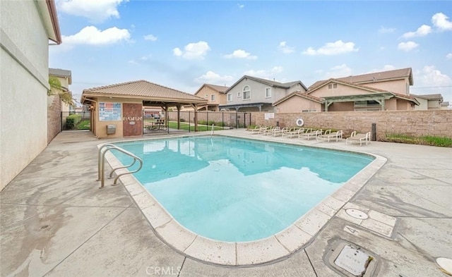 pool with a patio, a gazebo, and fence