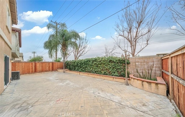 view of patio / terrace with a fenced backyard and central AC