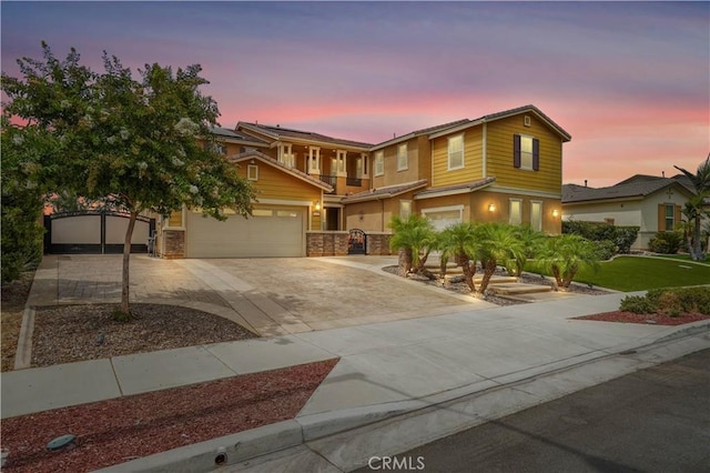 view of front of home with a garage, roof mounted solar panels, concrete driveway, and a gate