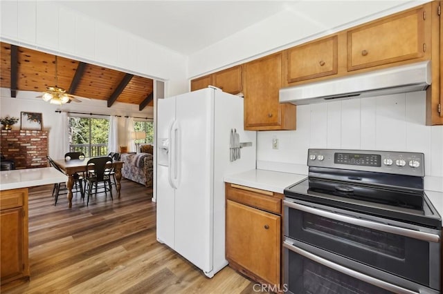 24950 Roble Dr, Idyllwild, CA 92549 - kitchen with range with two ovens, under cabinet range hood, white refrigerator with ice dispenser, wood ceiling, and light countertops