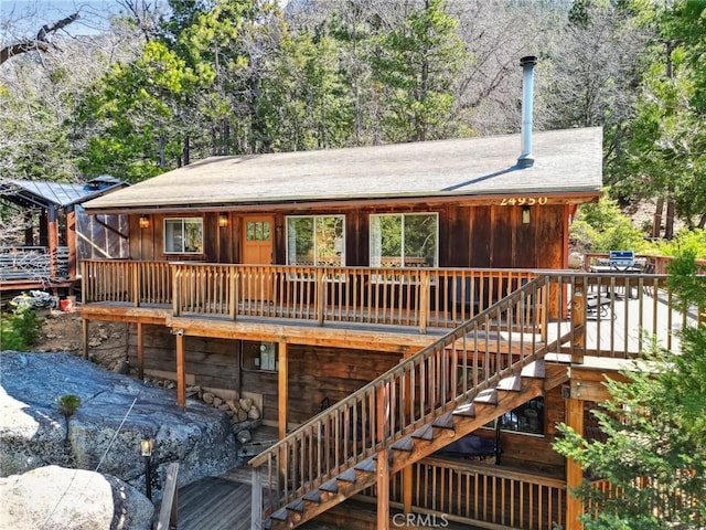 view of front of house featuring stairs and a deck