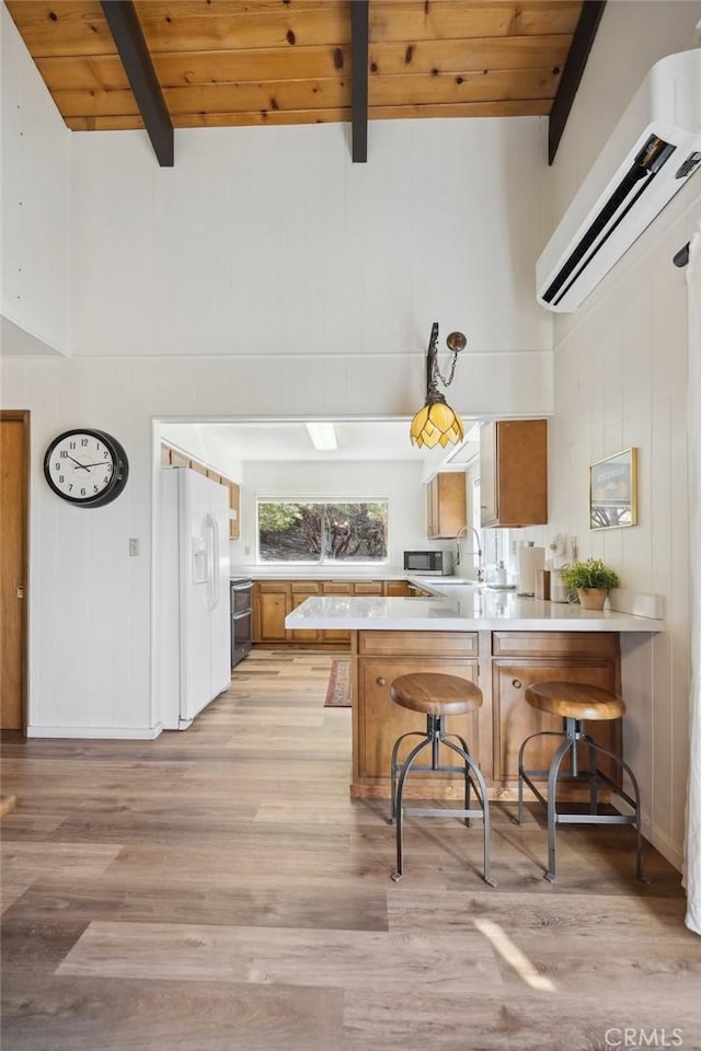 24950 Roble Dr, Idyllwild, CA 92549 - kitchen with white refrigerator with ice dispenser, beam ceiling, light countertops, wood ceiling, and a peninsula