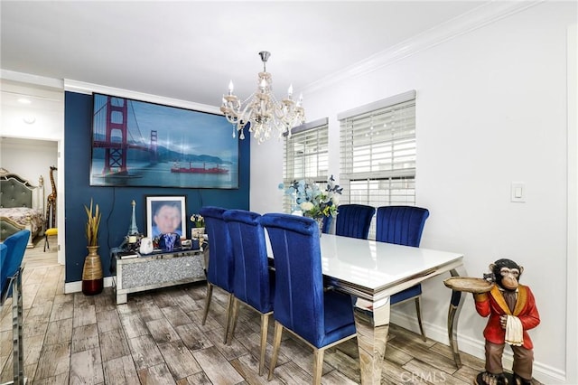 dining area with ornamental molding, wood tiled floor, a notable chandelier, and baseboards