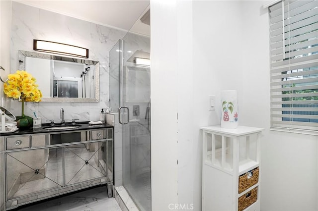 bathroom featuring marble finish floor, a shower stall, and vanity