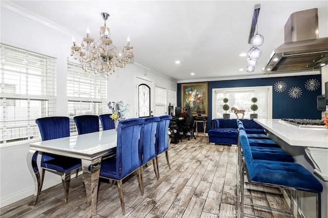 dining space with recessed lighting, crown molding, wood finished floors, baseboards, and an inviting chandelier