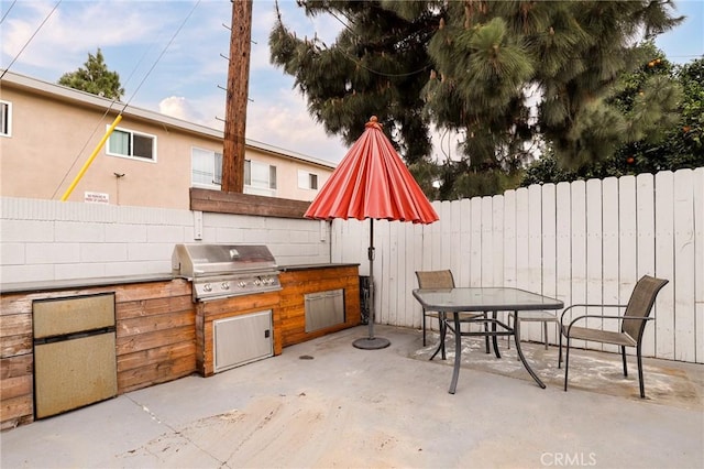 view of patio / terrace with outdoor dining area, area for grilling, and fence