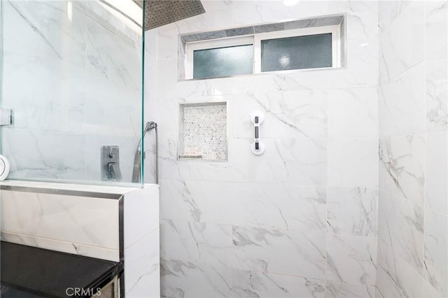 bathroom featuring a marble finish shower