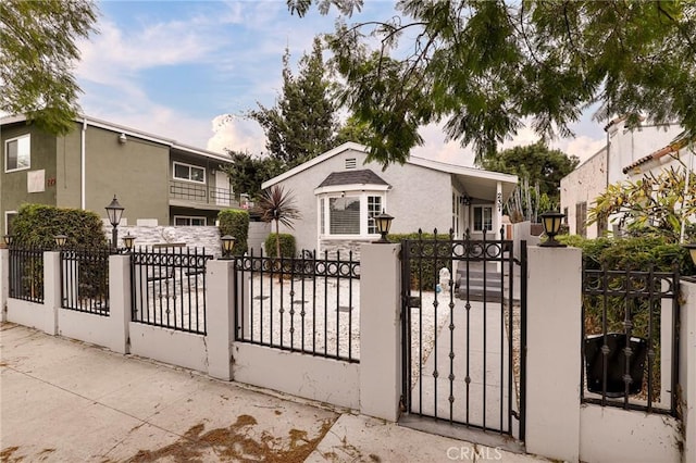 view of gate with a fenced front yard