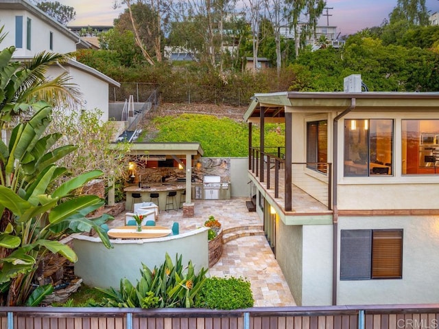 exterior space with a grill, fence, and area for grilling