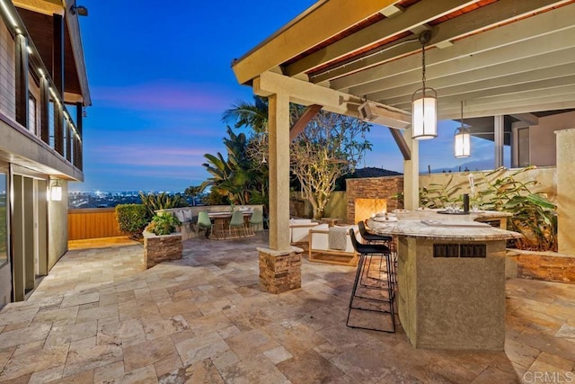 view of patio / terrace with outdoor dry bar and fence