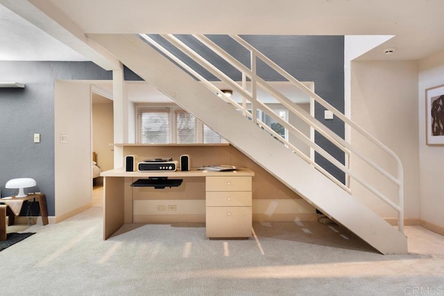 office space featuring light colored carpet and baseboards