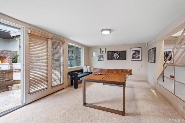 game room with baseboards and light colored carpet