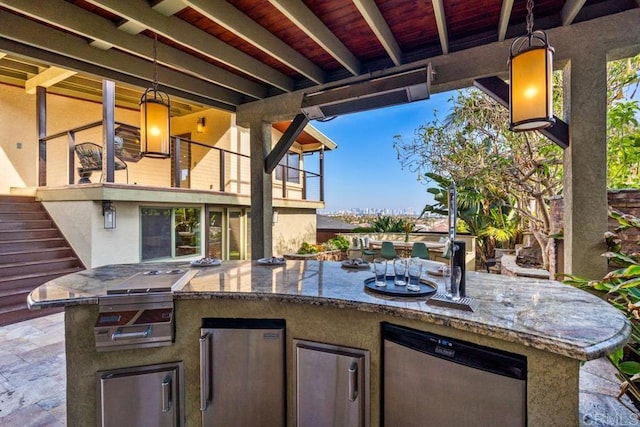 view of patio / terrace with a balcony, stairs, and an outdoor kitchen