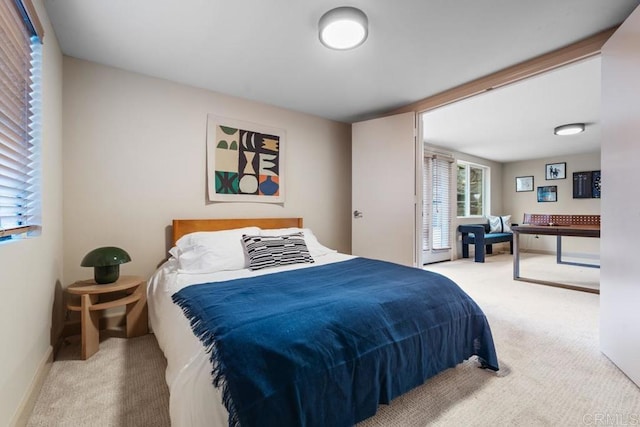 carpeted bedroom featuring baseboards