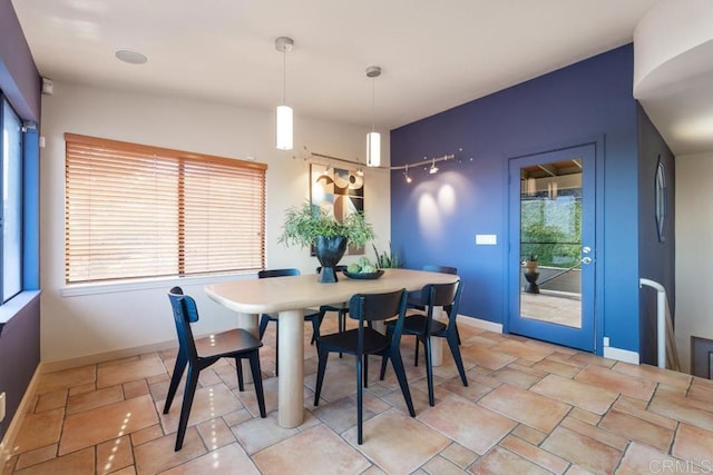 dining space featuring baseboards