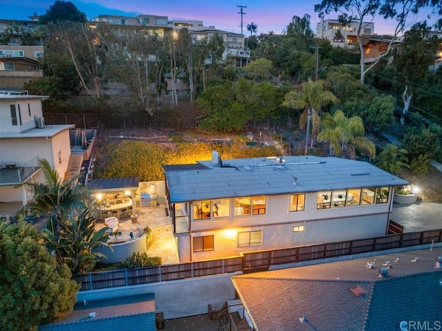 back of house featuring fence and stairs