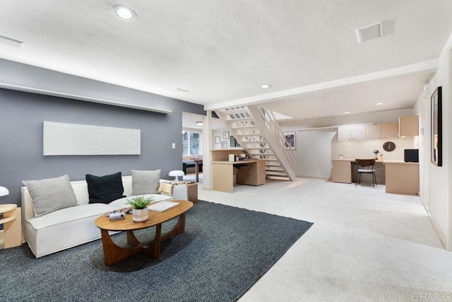 living area with light carpet, stairway, visible vents, and recessed lighting