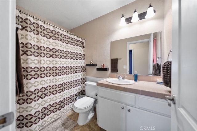 full bathroom with toilet, vanity, a shower with shower curtain, and a textured wall