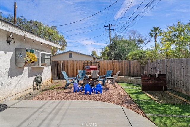 view of patio / terrace featuring a fenced backyard and a fire pit