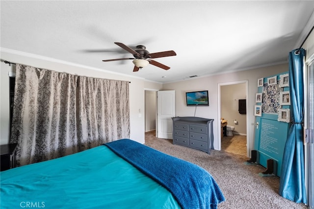 bedroom featuring visible vents, ceiling fan, ornamental molding, ensuite bathroom, and carpet