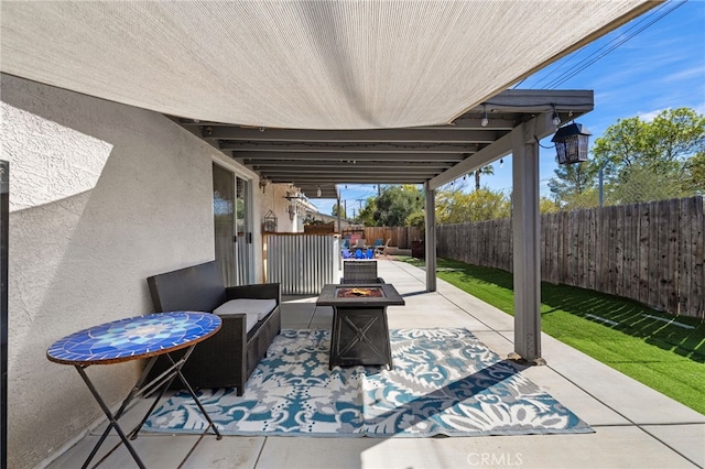 view of patio with an outdoor living space with a fire pit and a fenced backyard