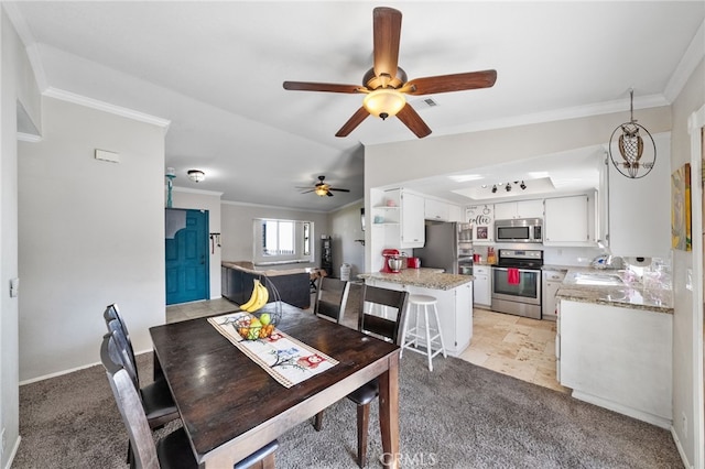 dining space featuring lofted ceiling, light colored carpet, and crown molding