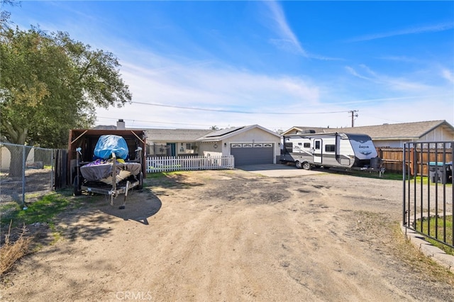 ranch-style house with driveway, an attached garage, and fence