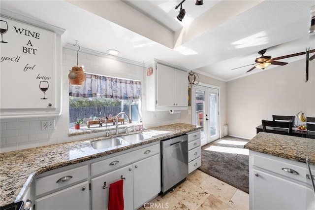 kitchen with backsplash, ornamental molding, white cabinets, a sink, and dishwasher