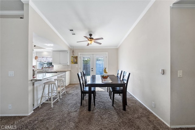 dining room with ornamental molding, french doors, and carpet flooring