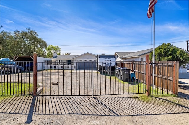 view of gate with a fenced front yard