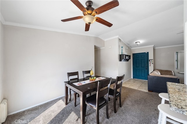 dining area with carpet floors, radiator, ornamental molding, vaulted ceiling, and baseboards