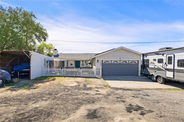 single story home with driveway, an attached garage, fence, and stucco siding