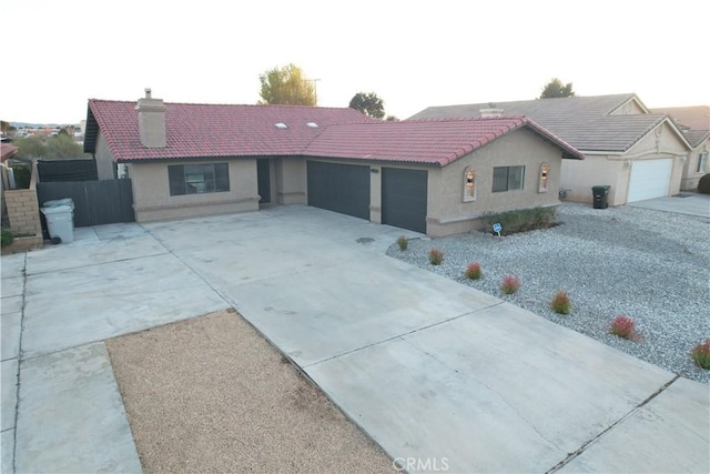 view of front of property with a garage, driveway, stucco siding, and a tiled roof