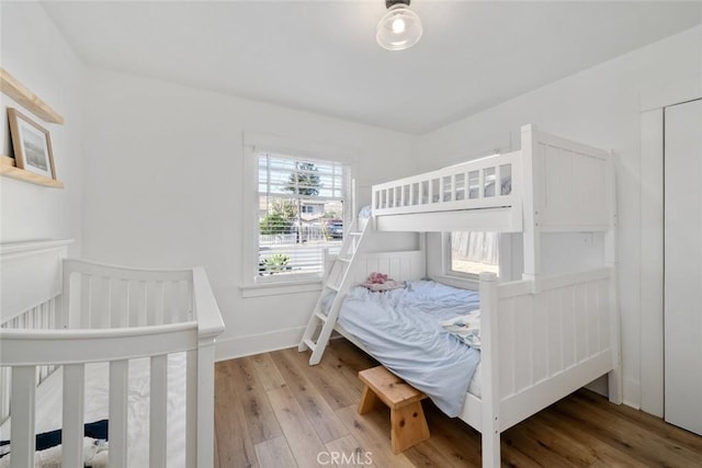 bedroom featuring light wood-style flooring and baseboards