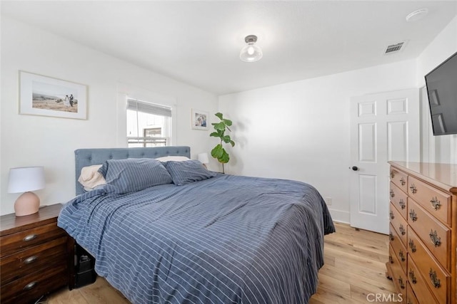 bedroom with visible vents and light wood-style flooring