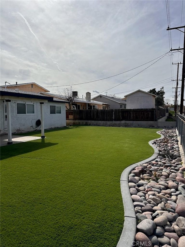 view of yard with a fenced backyard and a patio