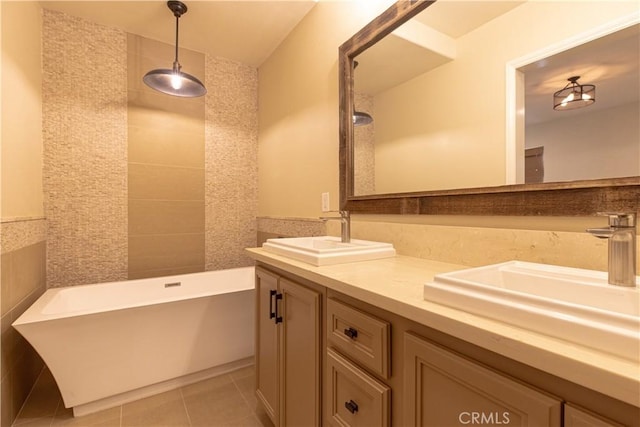 bathroom featuring double vanity, a sink, a freestanding tub, and tile patterned flooring