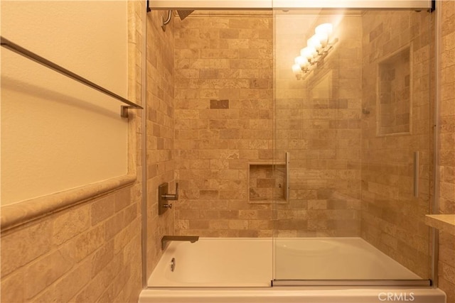 full bathroom featuring shower / bath combination with glass door