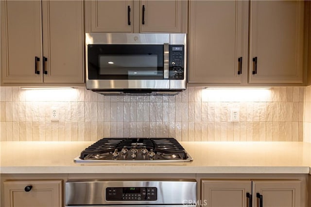 kitchen featuring backsplash, light countertops, and appliances with stainless steel finishes