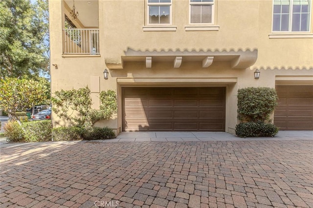 garage with decorative driveway